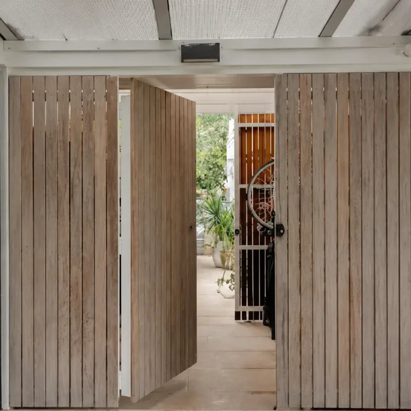Internal Carpentry Sydney modern living room with built-in timber shelving, wall panelling, and floating media cabinet in a bright contemporary home interior.