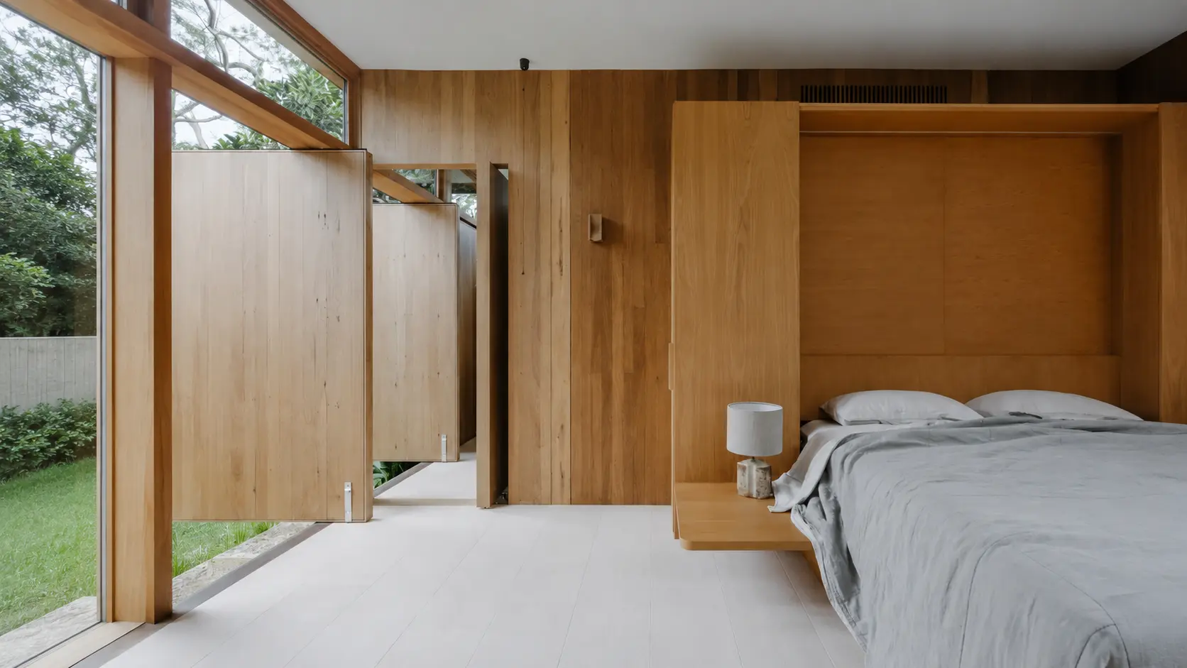 Modern living room showcasing Timber Feature Walls Sydney with vertical timber panels and warm ambient lighting