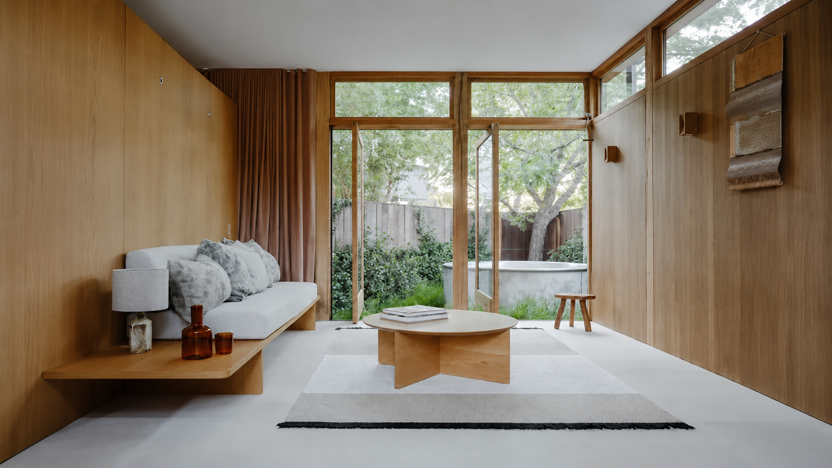 Compact Sydney apartment workspace featuring a custom built desk in Sydney with wall-mounted shelves, natural timber finish, and soft natural lighting.
