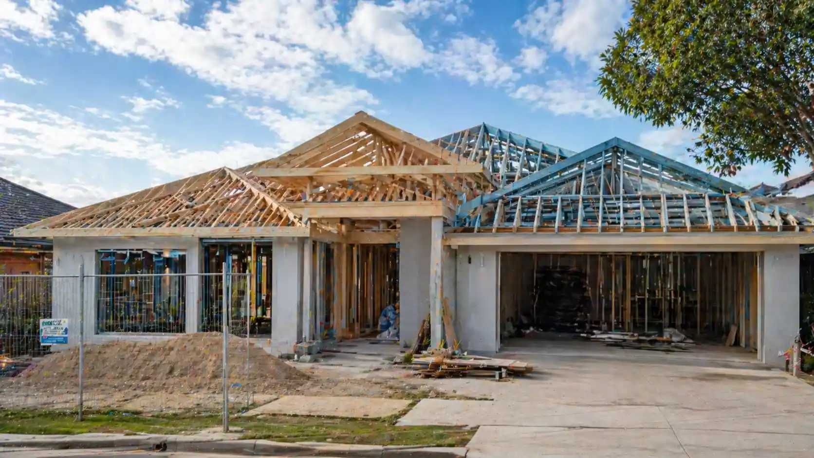 Structural roofing in Sydney showing exposed timber trusses and steel framing during residential roof construction stage